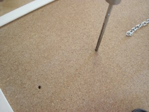 Poke holes where the drawer pull hardware goes.